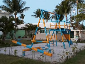a playground in front of a house at Areia do Atlantico Hotel in Porto Seguro