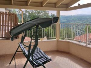 a treadmill in front of a balcony with a view at A Place To Remember in Ma‘alot