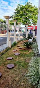 a row of stepping stones in the grass near a building at Pousada Tamandaré in Campo Grande +31 photos