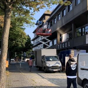 a man standing in front of a building at Central-Hotel Tegel in Berlin