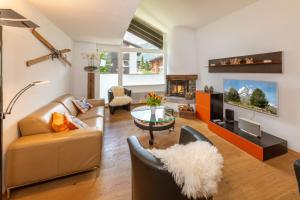 a living room with a couch and a fireplace at Ferienwohnung Haus Mia in Zermatt