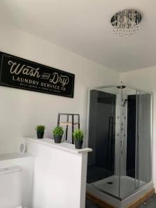 a bathroom with a shower and a sign on the wall at La Felicità classement ****vue Cathédrale! in Boulogne-sur-Mer