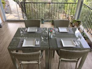 a table with two chairs and a table with glasses on it at D&C Göcek Hotel in Göcek
