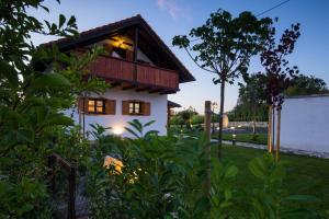 a house with a balcony on top of a yard at Villa Brallissima in Sveti Martin na Muri