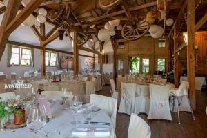 une salle de banquet avec des tables blanches et des chaises blanches dans l'établissement Freiämter Hof, à Freiamt