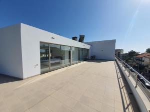 a large white building on top of a roof at Figueira Beach Apartment in Buarcos
