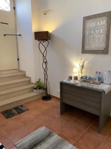 a room with a desk with a sign on the wall at Le Dimore di San Domenico Affittacamere in LʼAquila