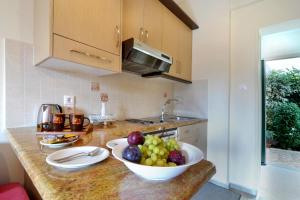 a kitchen with a bowl of fruit on a counter at Rhea Complex in Paleokastritsa