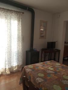 a bedroom with a bed and a window with curtains at STUDIO WITH TENIS COURT AND MINI BASKET in Aigio