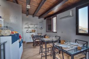 a kitchen and dining room with tables and chairs at Cefalu in Blu in Cefalù