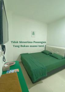 Letto o letti in una camera di Anugrah Inn