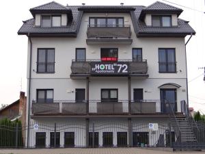 a hotel with a sign on the side of a building at Hotel Apartamenty 72 in Płock