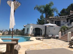 a house with a swimming pool in front of a house at Villa Finca Costa Blanca Apartment 1 / Ferienwohnung 1; Monte Pego bei Denia in Monte Pego