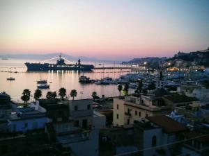 a large ship is docked in a harbor at sunset at Blue Eyes L'INCANTESIMO SUL MARE in Gaeta