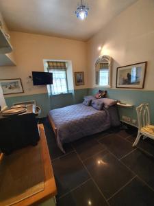 a bedroom with a bed and a table and chairs at Leithen Lodge in Innerleithen