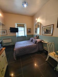 a bedroom with a bed and a desk and a table at Leithen Lodge in Innerleithen