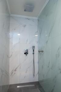 a shower with a glass door in a bathroom at Mr & Mrs K Lofts in Potos +15 photos
