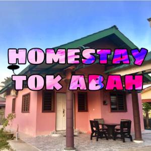 a house with a sign that reads home stay top agent at Homestay TokAbah in Pasir Puteh
