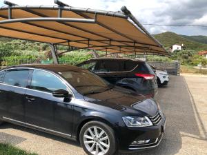 a car parked in a parking lot with a canopy at Astra Sarti Luxury Suites in Sarti