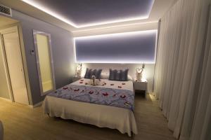 a bedroom with a large bed and a large window at Masd Mediterraneo Hotel Apartamentos Spa in Castelldefels