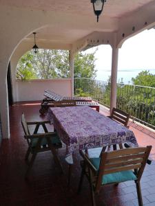 a patio with a table and chairs on a balcony at Apartments Bassi in Stara Baška