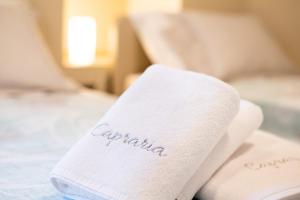 a towel with the word eczema sitting on a bed at CAPRARIA appartments in historic center, with private parking in Koper
