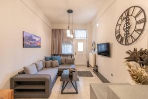 a living room with a couch and a tv at Oikion Meteora Home 1 in Kalabaka