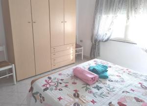 a bedroom with a bed and a dresser at BaseCamp Ogliastra - Flat White in Santa Maria Navarrese