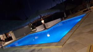 an overhead view of a blue swimming pool at night at Eco Paradise Cumbuco 131 in Cumbuco