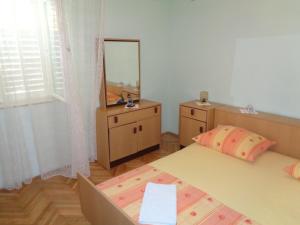 a bedroom with two beds and a mirror and a dresser at APARTMAN ZORAN MARUSIC in Marusici 