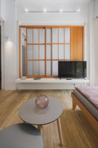 A television and/or entertainment centre at Sun-splashed Stylish Flat, steps to City Old Town