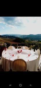 a white table with chairs and a white table cloth at Agriturismo Le Francesche in Nocera Umbra