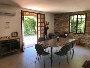 a dining room with a table and chairs and a fireplace at En Buena Hora in Saze