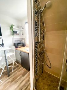 a shower in the corner of a kitchen with a table at Castle - Vue sur le château - Hypercentre in Caen