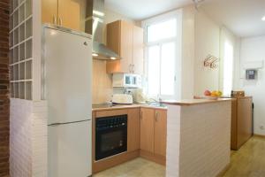 a kitchen with a refrigerator and a counter top at La Fira in Barcelona +16 photos