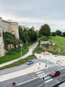 a street in front of a castle with cars parked at Castle - Vue sur le château - Hypercentre in Caen