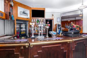 a bar with a wooden counter top with a bartender at The Roman Bath in York
