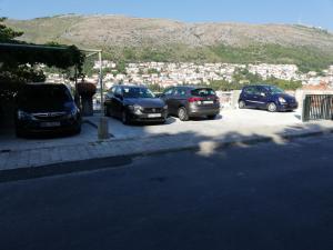 a group of cars parked in a parking lot at Apartment Gitara in Dubrovnik