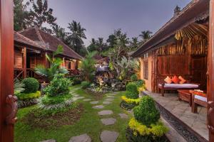 a garden in front of a house at Green Zone Ubud Villas by Pramana Villas in Ubud