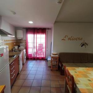 a kitchen with a couch and a table in a room at Can Panxeta in Pallaresos