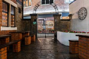 an entrance to a building with a gate and flowers at The Roman Bath in York +16 photos