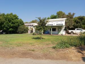 a house with a truck parked in a yard at ZEHAVI Guest House in Lahavot HaBashan