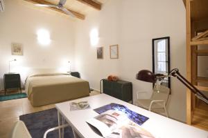 a bedroom with a bed and a desk with a table at Grand Harbour Apartments in Il-Furjana