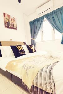 a bedroom with a bed with blue curtains and a window at Kepong Homestay by Warm Home in Kuala Lumpur