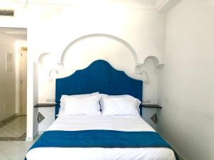 Postel nebo postele na pokoji v ubytování Hotel Reginella