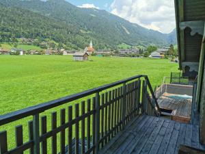 a porch of a house with a view of a field at Ferienwohnung auf der Scheibe in Bezau