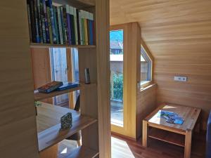 a small room with a book shelf and a table at Ferienwohnung auf der Scheibe in Bezau