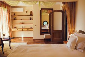 a bedroom with a large bed and a mirror at Denisa Boutique in Poiana Brasov +37 photos