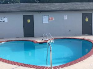 a large swimming pool in front of a building at Travelodge by Wyndham Clarksville in Clarksville