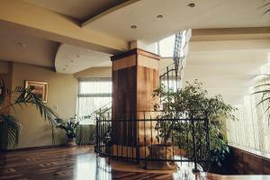 a room with plants and a column with windows at Denisa Boutique in Poiana Brasov